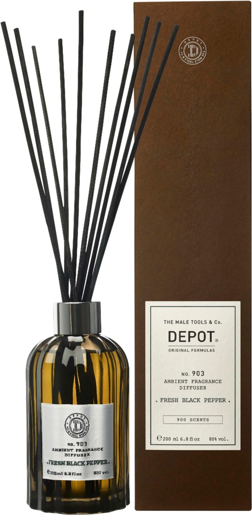 A brown box and a glass bottle with black sticks, labeled 'Depot' with a pepper scent.