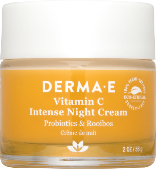 Een pot nachtcrème met oranje en wit label, noemt vitamine C, probiotica en milieuvriendelijke claims.