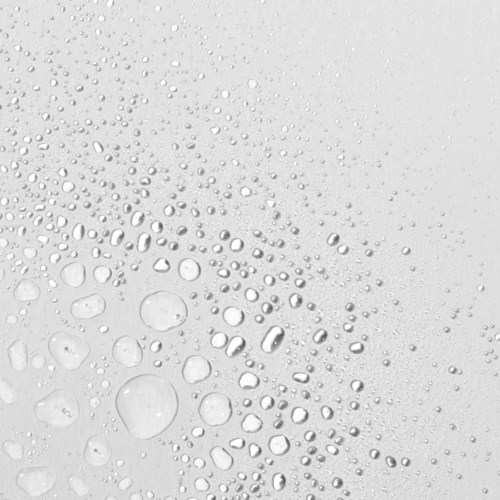Waterdruppels van verschillende maten op een wit oppervlak, vormen een patroon.