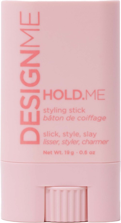 Pink styling stick with text: 'DESIGN ME HOLD.ME'. It is a makeup or hair styling product.