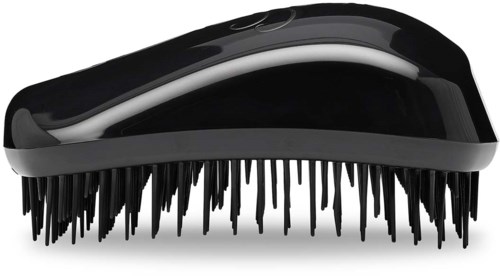A black electric grooming brush with a curved shape and many small black bristles.