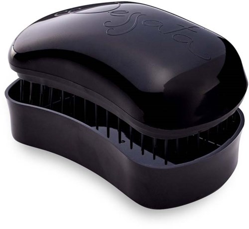 A black oval-shaped hairbrush with vent holes, featuring the word 'Tangle' embossed on the top.