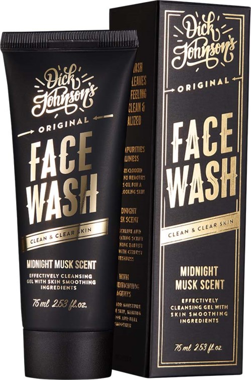 En svart tube med tilsvarende eske, begge merket 'Dick Johnson Face Wash,' med hvit og gull tekst, som indikerer et hudpleieprodukt.