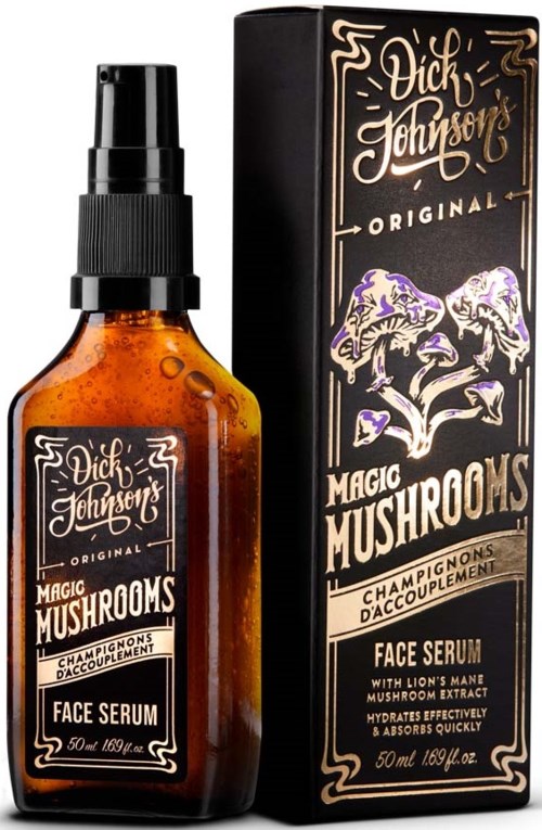 A small amber-colored bottle of face serum with a black spray cap next to a black box, both labeled 'Magic Mushrooms.'