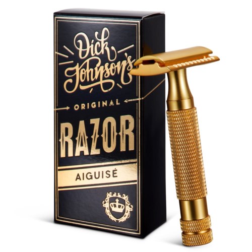 A gold safety razor and a black box with gold and white text. The box says "Vik Johnson's Original Razor Aiguisé."