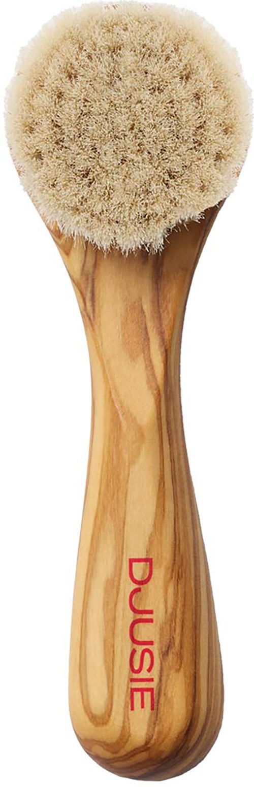 Ein Holzborste mit rundem, weichem Borstenkopf und dem Markennamen "DUUSIE" am Griff.