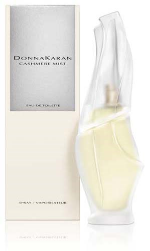 Een parfumfles met een slank, gebogen glazen ontwerp naast een witte doos met 'DONNA KARAN CASHMERE MIST.'