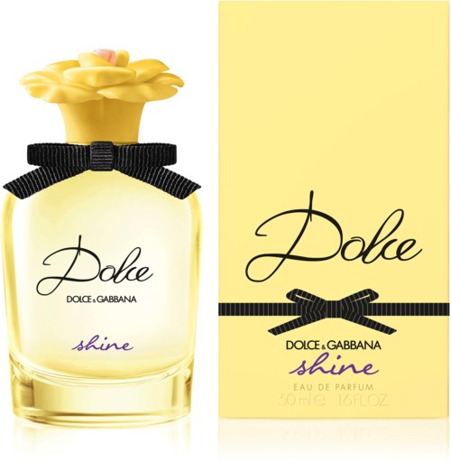 En parfyllflaska med en gul blomformad kork, svart band och en gul box. Märket är Dolce Gabbana Shine.