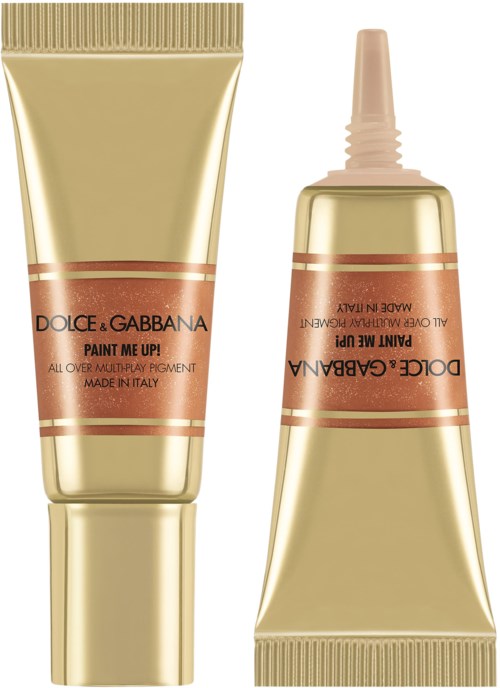 Two gold-colored tubes of Dolce & Gabbana Paint Me Up makeup with pink caps, one open showing the applicator.
