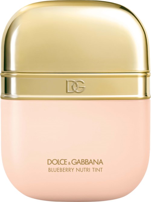 Ett litet runt kosmetikaförpackning med guldlucka och rosa botten. Det är en Dolce & Gabbana blåbär Nutri Tint.