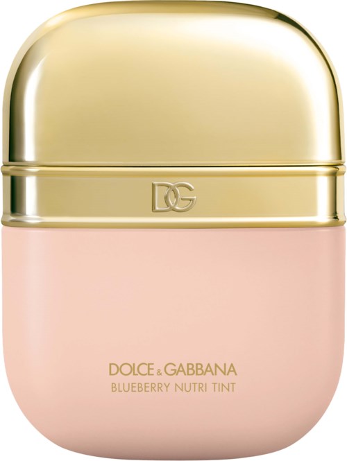 En liten, rosa kosmetikbehållare med ett glänsande, guldlock och gul text som säger 'DOLCE & GABBANA BLUEBERRY NUTRI TINT.'