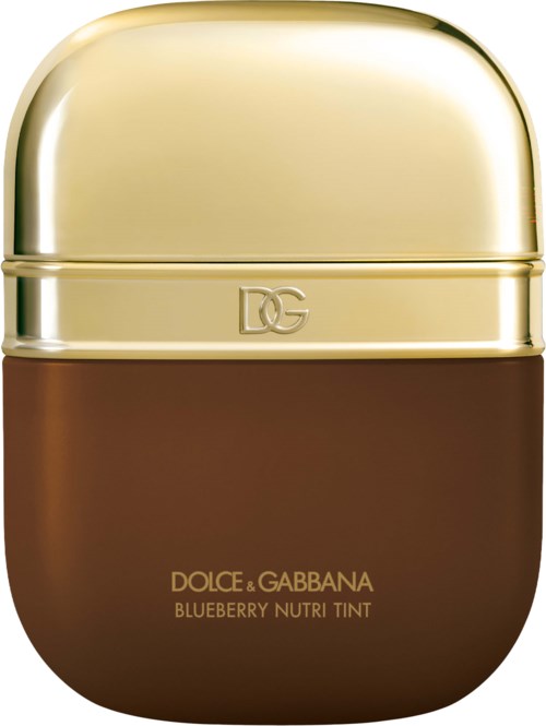 A compact container with a gold top and brown bottom, labeled Dolce & Gabbana blueberry nutri tint.