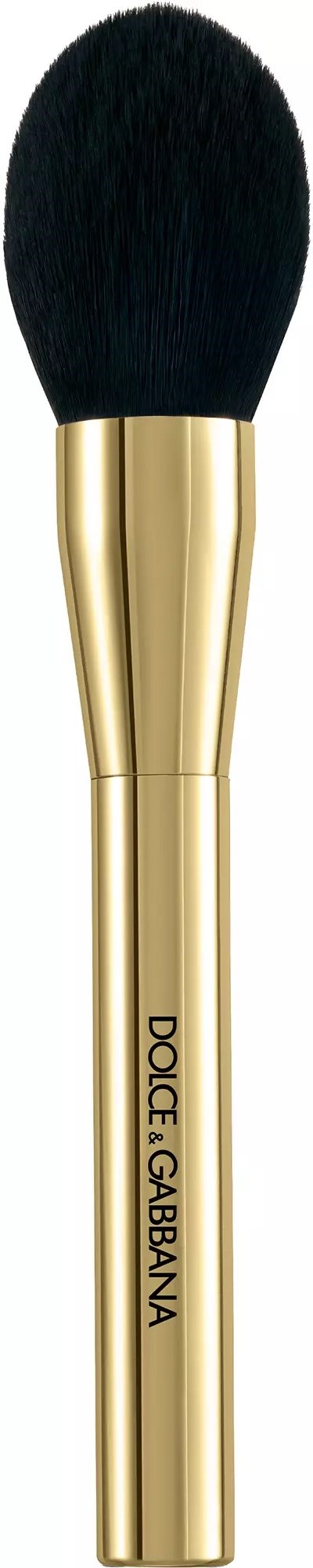 Ein Make-up-Pinsel mit schwarzem, flauschigem Kopf und goldenem Griff, beschriftet Dolce & Gabbana.