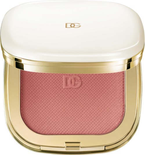 A compact with a white lid and a pink blush inside, decorated with gold accents and a logo on top.