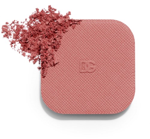 A pink makeup blush compact with crushed blush on top and textured surface.