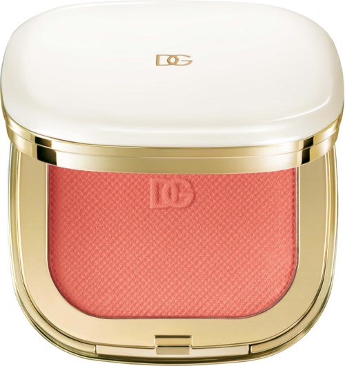 A compact blush with a white lid and gold edges, containing pink powder for makeup.
