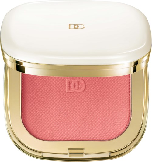 A compact makeup case with a pink blush and a gold and white exterior.