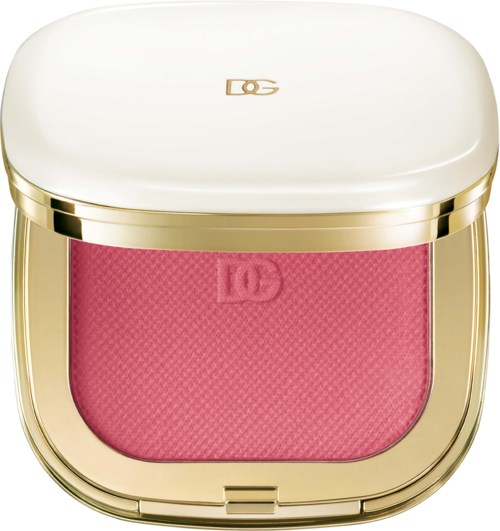 A compact with a white lid and a pink blush inside, bordered by a gold edge.