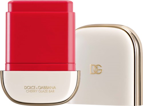 A red lipstick container with a gold and white case next to it, labeled Dolce and Gabbana cherry glaze bar.