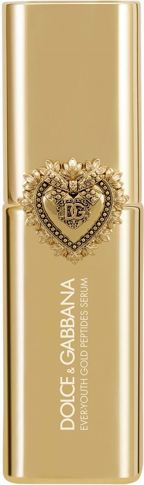 En guldfärgad flaska av Dolce & Gabbana Youth Gold Peptides Serum med ett dekorativt hjärteemblem på framsidan.