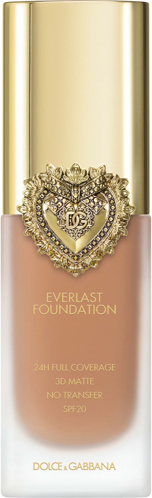 A bottle of foundation with a gold cap, a heart-shaped jewel, and brand details in gold and pink colors.