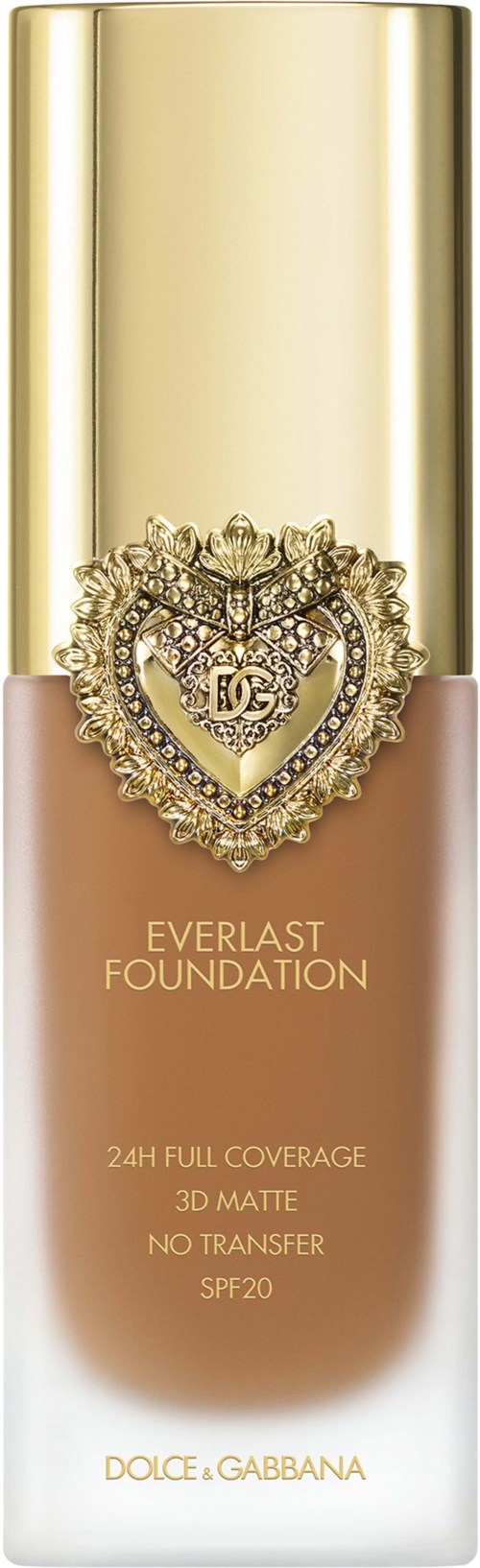 A foundation bottle with a gold cap, decorative heart emblem, and beige label with product details.