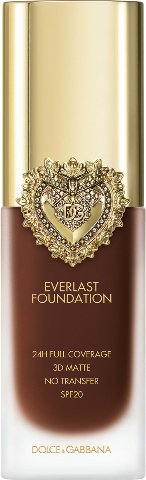 A foundation bottle with a gold cap, a heart-shaped decorative emblem, and text describing coverage and SPF.