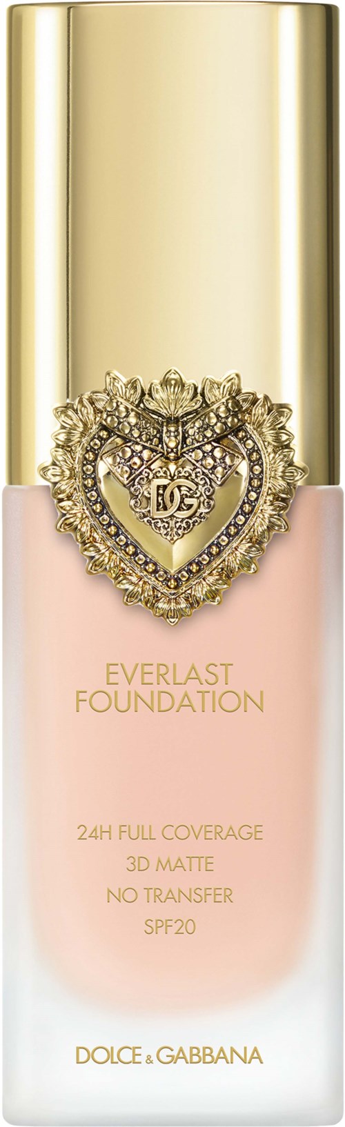 A bottle of Dolce & Gabbana Everlast Foundation, pink liquid, gold cap, with a heart-shaped jewel decoration.