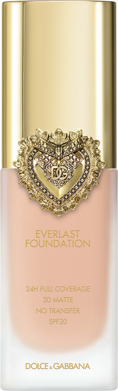 A foundation bottle with a gold cap, pink base, and a heart-shaped jewel logo on the front.