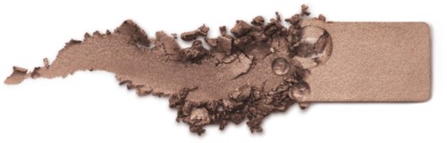 A beige makeup sponge with powder scattered around it, showing a cosmetic product.