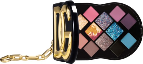 A designer bag with colorful eyeshadow palettes inside and a gold chain handle.