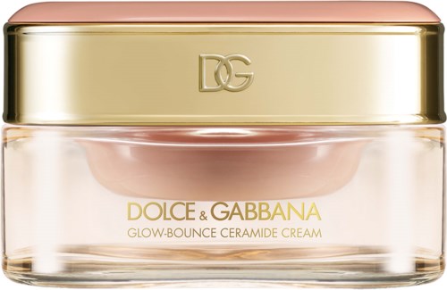 En lyxig krämkanna med rosa och gulddesign, märkt Dolce & Gabbana Glow-Bounce Ceramide Cream.