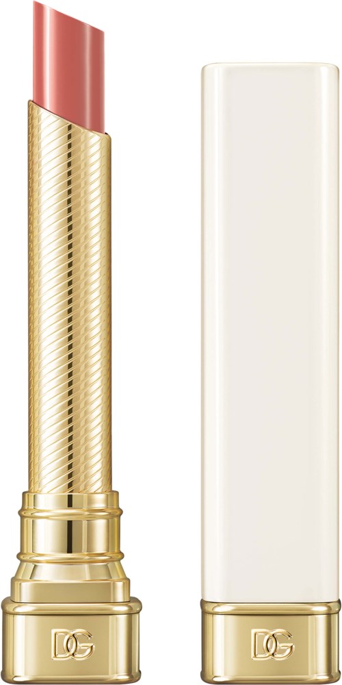 A lipstick with a gold case and a white box next to it, against a plain background.
