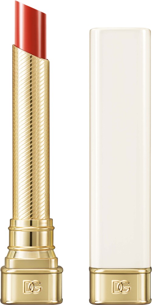 A gold lipstick tube with a red lipstick and a white rectangular case next to it.