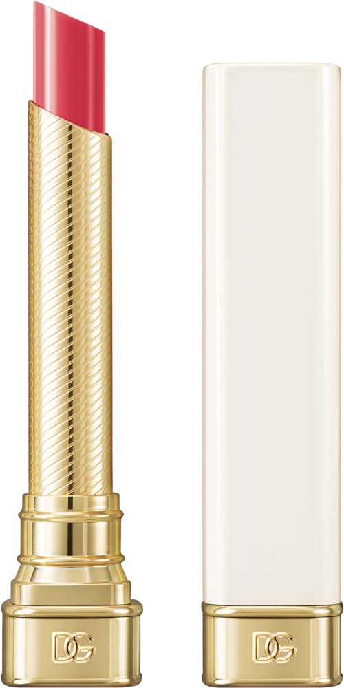 A lipstick with a gold case and a white cap, showing bright pink lipstick inside.