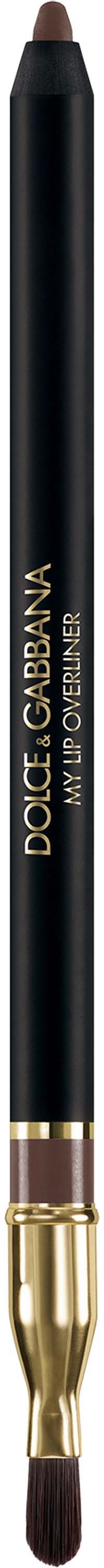 A black makeup brush with a gold and purple handle, labeled Dolce & Gabbana My Urban in gold text.