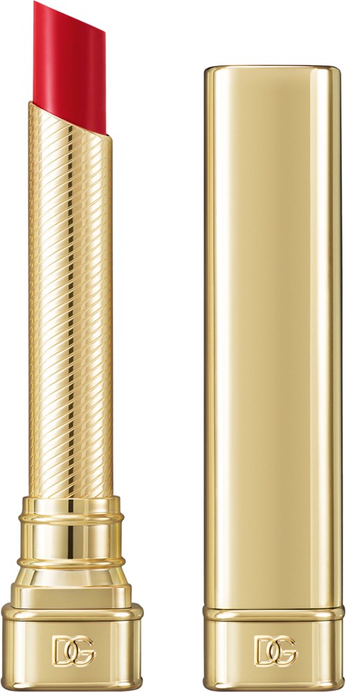 A gold lipstick tube with the cap beside it, both with a logo at the base.