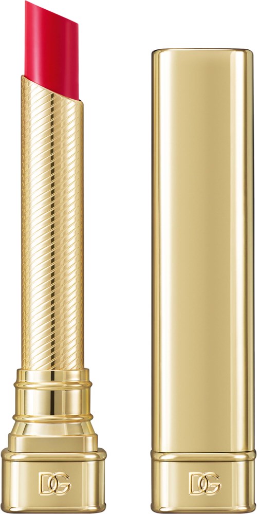 A gold lipstick tube with a red lipstick bullet exposed, and the cap placed beside it.