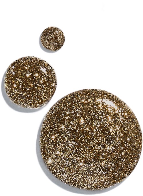 Three round stones with glittering gold and white specks on a white background.