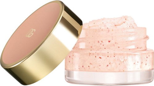 A jar of pink, creamy facial or body scrub with a gold lid, slightly open.