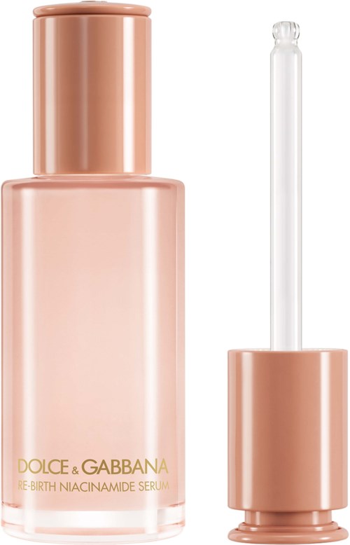 En rosa serumflaska med en pipett, märkta 'DOLCE & GABBANA RE-BIRTH NIACINAMIDE SERUM'.