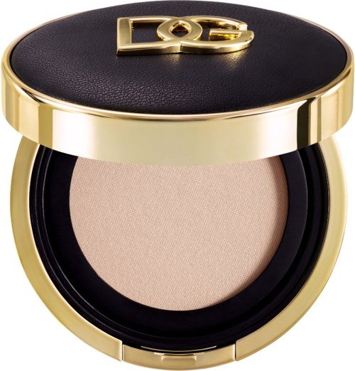 Die Make-up-Box ist rund mit Schwarz und Gold, enthält beige Puder.
