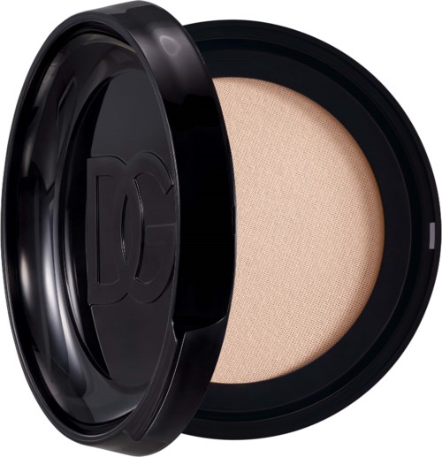 Ein runder Make-up-Compact mit beige Puder im Inneren und einem schwarzen Deckel.