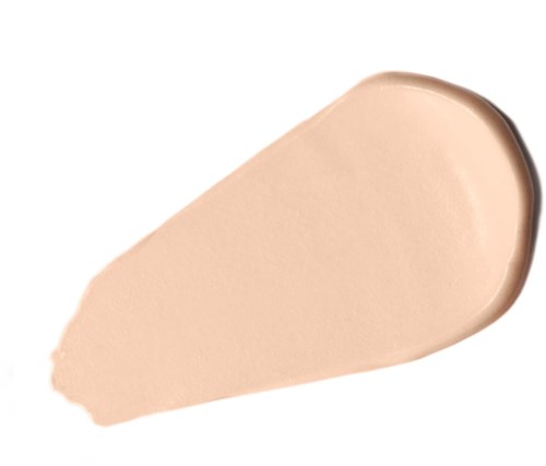Eine beigefarbene Creme oder Grundierung, verteilt mit einer gerundeten Kante auf weißem Hintergrund.