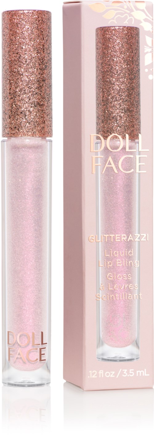 Lippen Gloss namens Doll Face in einer klaren Tube mit pinkem Glitzer, neben ihrer rosa Verpackung.