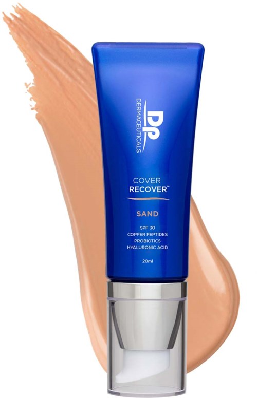 Blue tube of skincare cream with a silver pump, labeled 'Cover Recover Sand,' against a beige background.