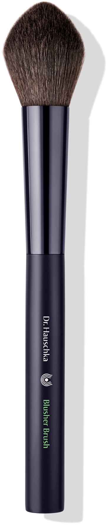 A dark makeup brush with a rounded top and green text on the handle. The background is black.