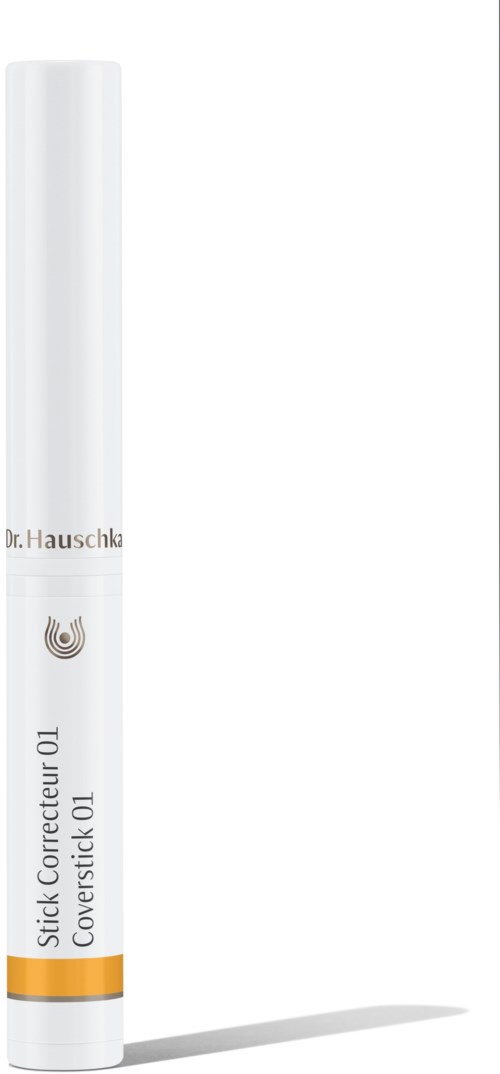 A white tube with a label indicating it contains a corrector. It has orange and gray marks.
