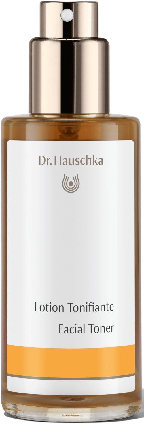 A brown facial toner bottle with a white label, gold cap, and spray nozzle.