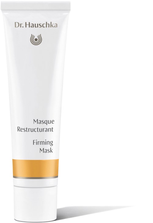 En vit tub med guldkant, märkt 'Dr. Hauschka Reconstructing Firming Mask.'